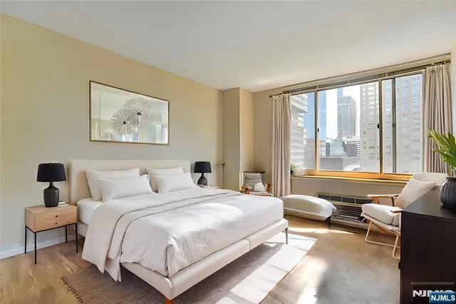 a bedroom with a large bed and a large window