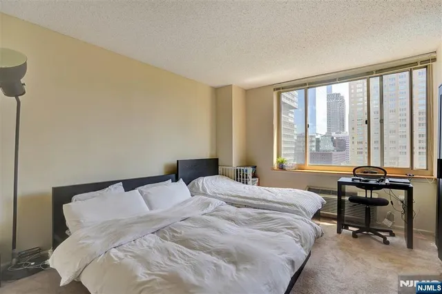 a bedroom with a bed and a windows