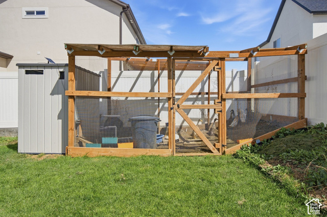 1113 South Raintree Lane Santaquin, UT 84655 - Photo 48 of 59 Expansive yard featuring a wooden animal enclosure, a gray storage shed, and a privacy fence