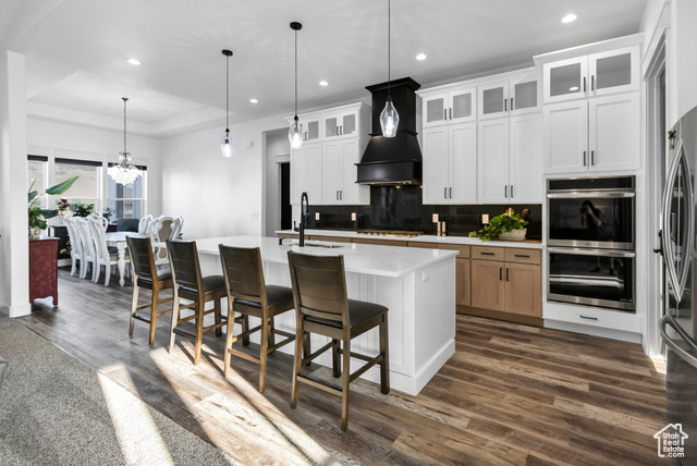 1952 Highway 118 Monroe, UT 84754 - Photo 18 of 88 Kitchen featuring appliances with stainless steel finishes, light countertops, decorative backsplash, a chandelier, and dark wood-style floors
