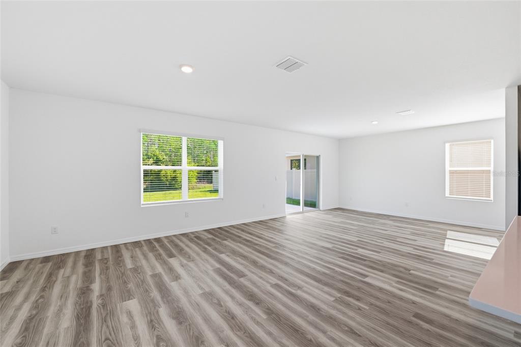 17786 Acorn Drop Road Land O Lakes, FL 34638 - Photo 12 of 50 wooden floor in an empty room with a window