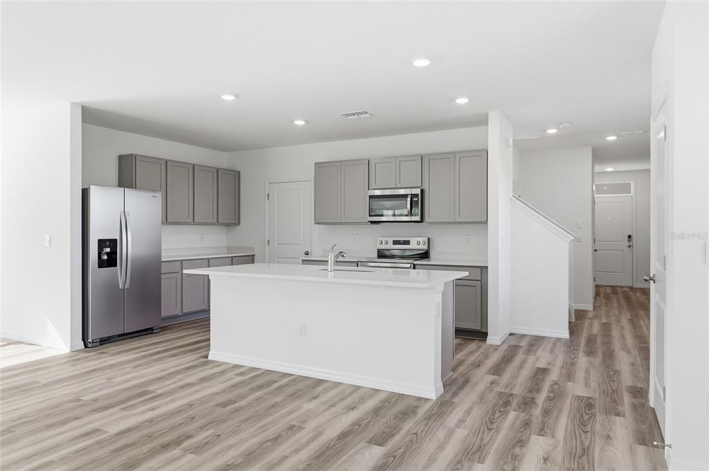 17786 Acorn Drop Road Land O Lakes, FL 34638 - Photo 15 of 50 a kitchen with stainless steel appliances a refrigerator sink and cabinets