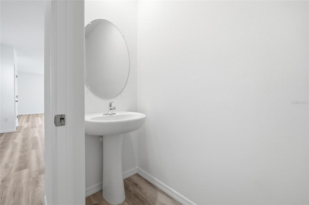 17786 Acorn Drop Road Land O Lakes, FL 34638 - Photo 18 of 50 a bathroom with a sink a toilet and a mirror
