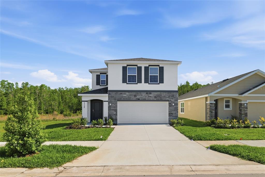 17786 Acorn Drop Road Land O Lakes, FL 34638 - Photo 2 of 50 a front view of a house with a yard and garage