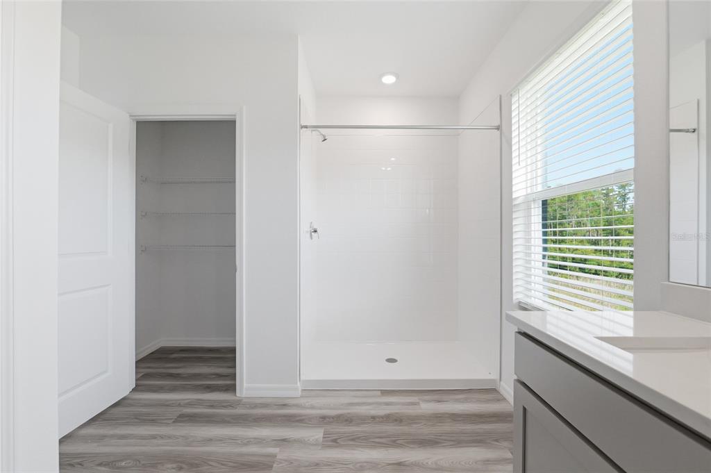 17786 Acorn Drop Road Land O Lakes, FL 34638 - Photo 22 of 50 a view of an empty room with wooden floor and a window