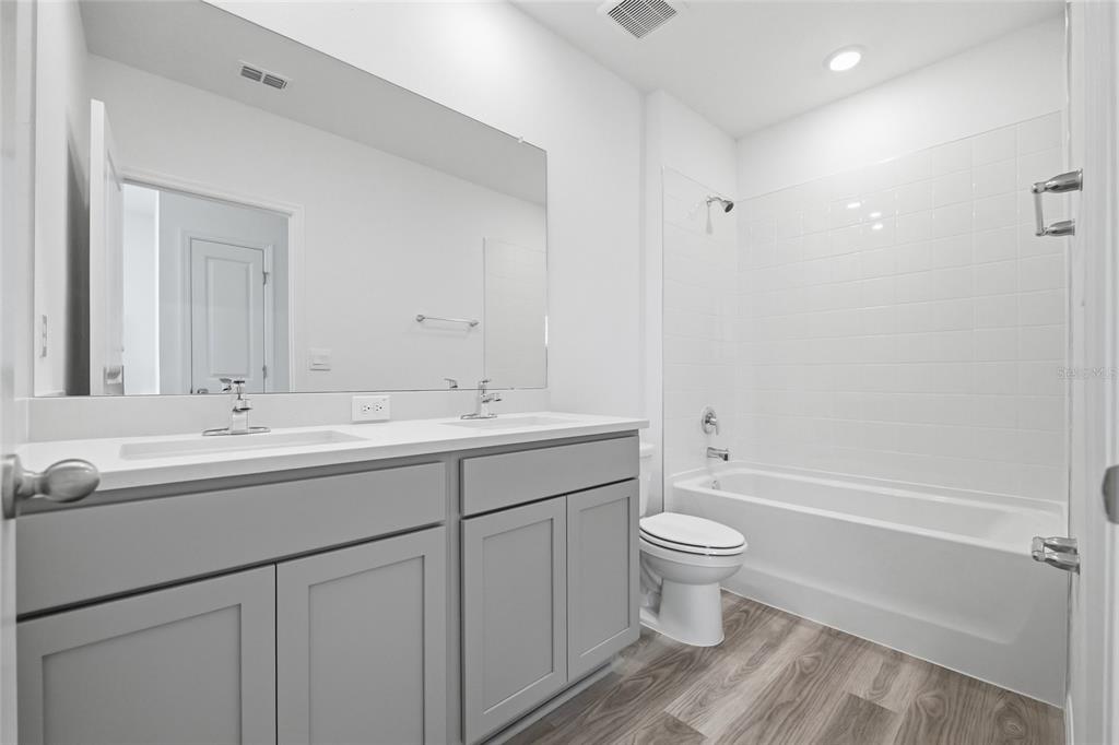 17786 Acorn Drop Road Land O Lakes, FL 34638 - Photo 28 of 50 a bathroom with a sink toilet and a mirror