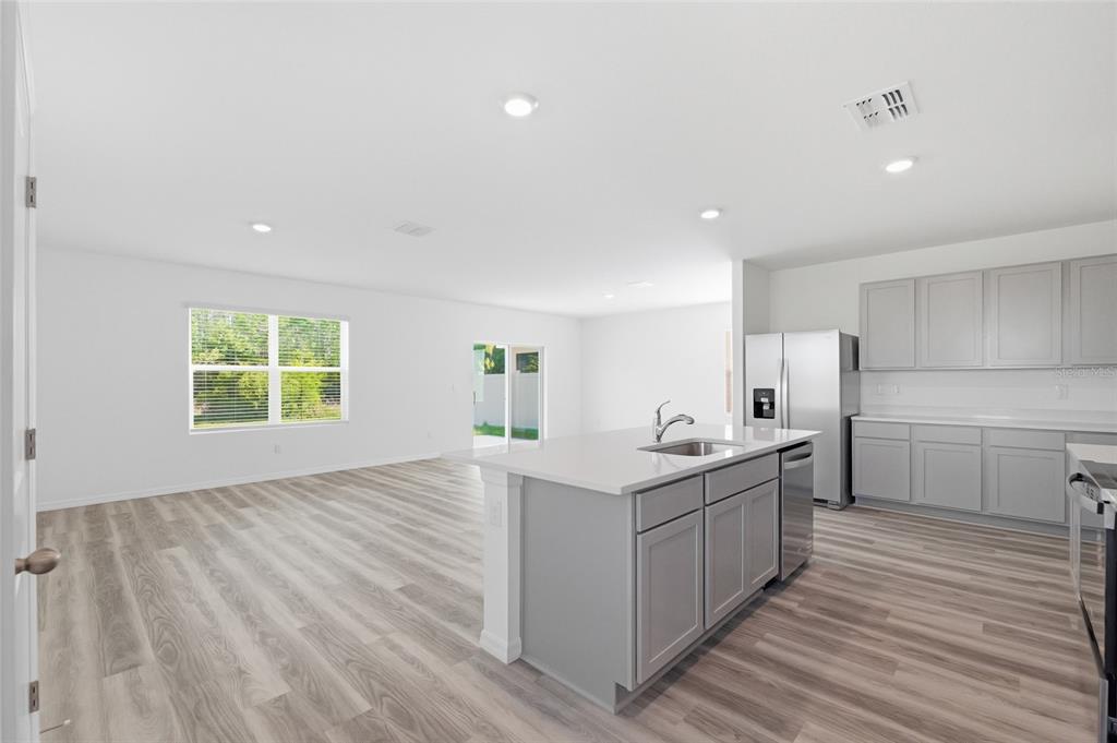 17786 Acorn Drop Road Land O Lakes, FL 34638 - Photo 10 of 50 a kitchen with a sink stove and cabinets