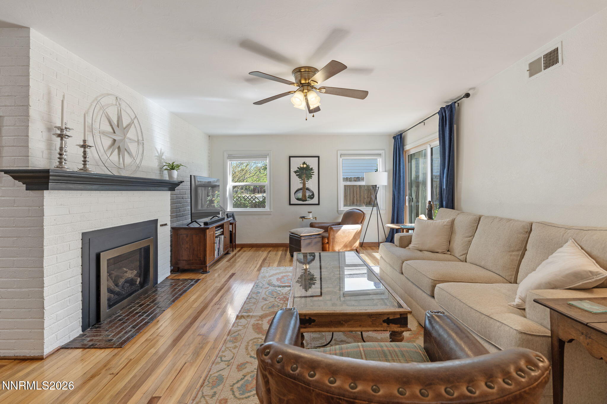 300 Country Club Drive Reno, NV 89509 - Photo 12 of 48 a living room with furniture a fireplace and a large window
