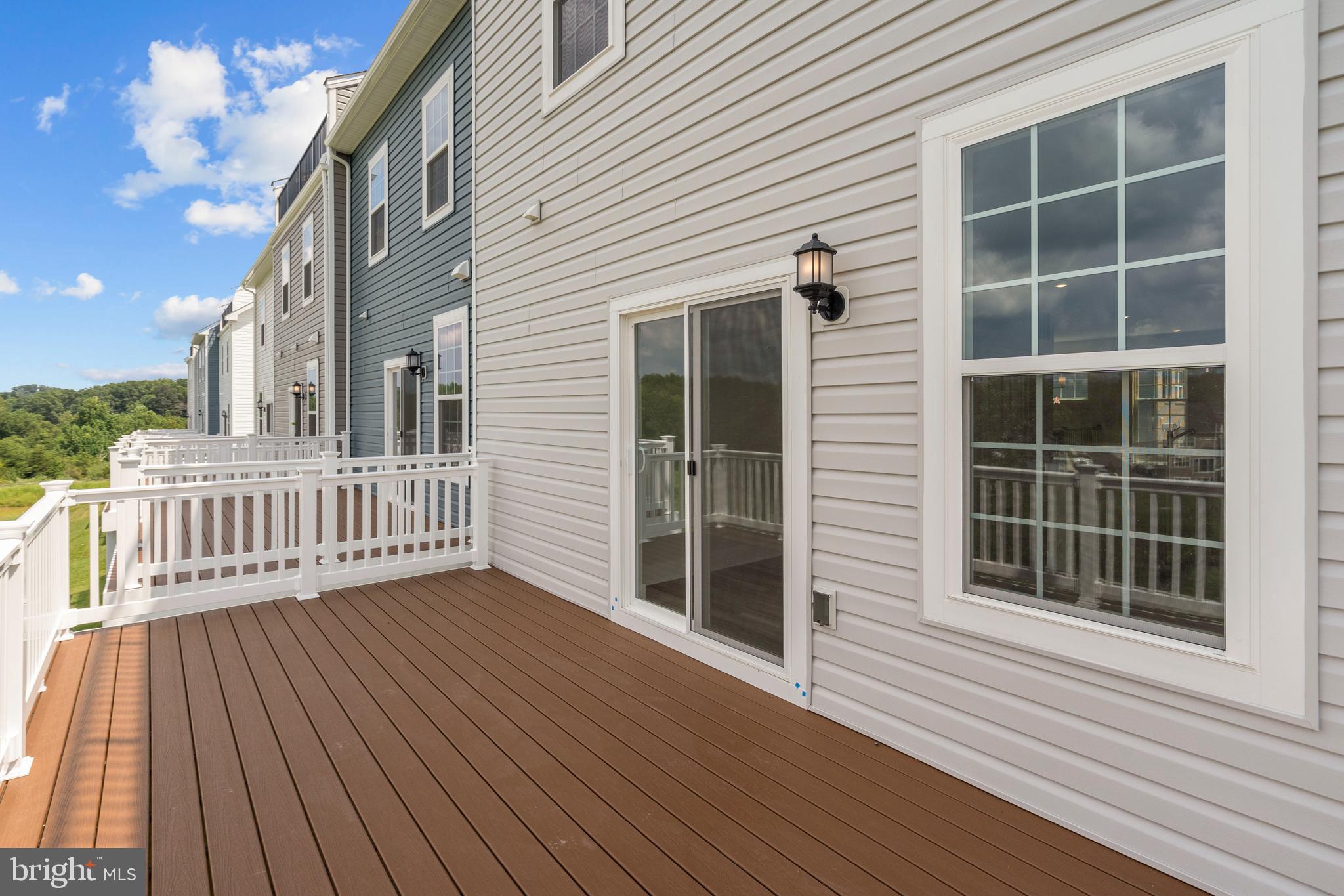 516 Downswing Road Pikesville, MD 21208 - Photo 3 of 5 a view of a house with wooden deck