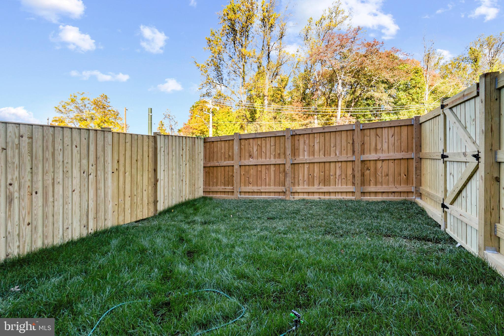 516 Downswing Road Pikesville, MD 21208 - Photo 5 of 5 a view of backyard with wooden fence