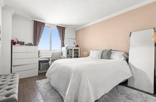 a bedroom with a bed and a dresser