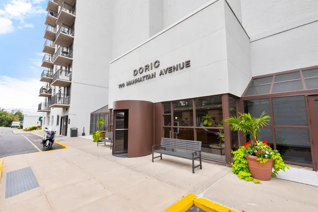 a front view of a building with sitting area