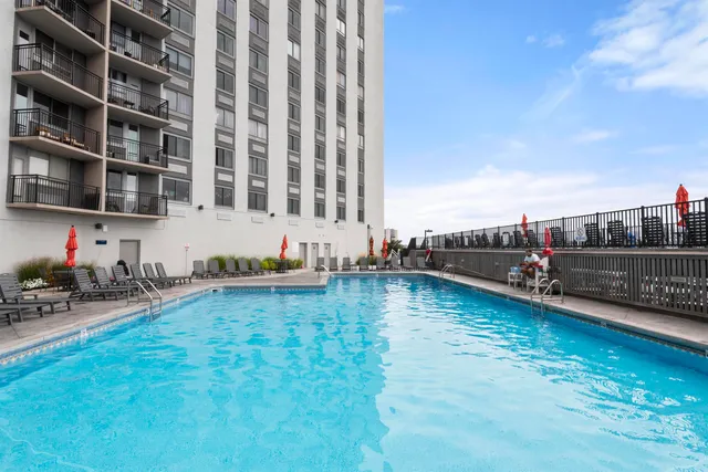 a view of a swimming pool and lounge chair