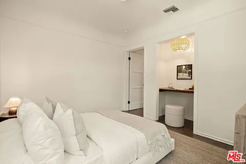 a bedroom with a bed and a night stand