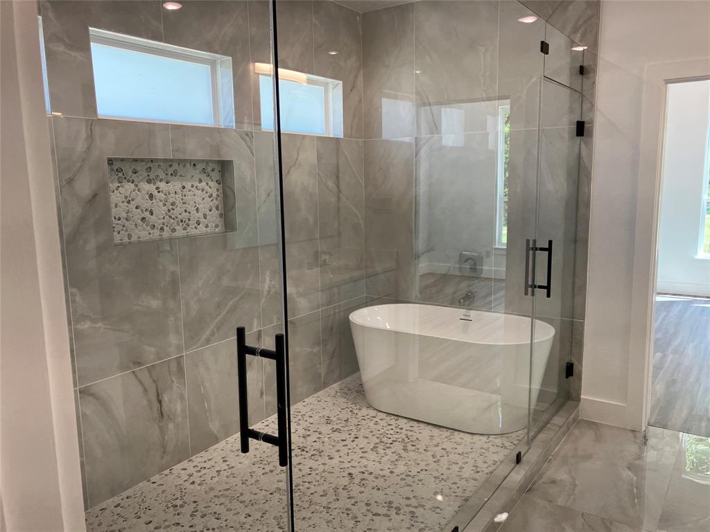 42101 Crooked Stick Drive Whitney, TX 76692 - Photo 14 of 27 a bathroom with a bathtub and shower