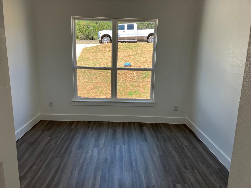 42101 Crooked Stick Drive Whitney, TX 76692 - Photo 16 of 27 an empty room with a window and wooden floor