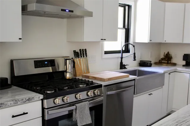 a kitchen with a stove and a white cabinets