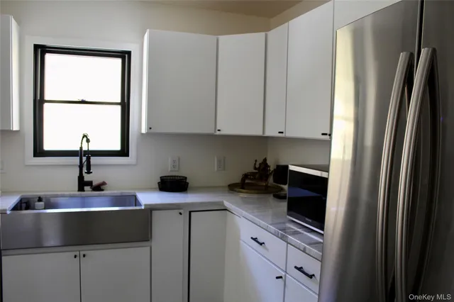 a kitchen with stainless steel appliances a sink stove and cabinets