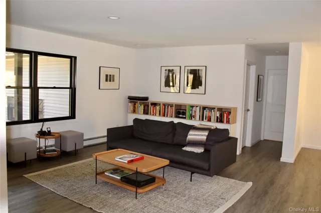a living room with furniture a rug and a window