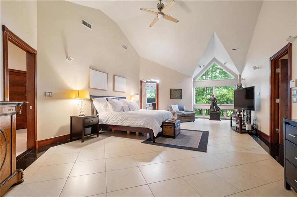 139 Witherow Road Sewickley, PA 15143 - Photo 19 of 41 a spacious bedroom with a bed a flat screen tv and a large window