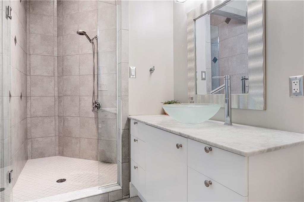 139 Witherow Road Sewickley, PA 15143 - Photo 23 of 41 a bathroom with a granite countertop sink a mirror and shower