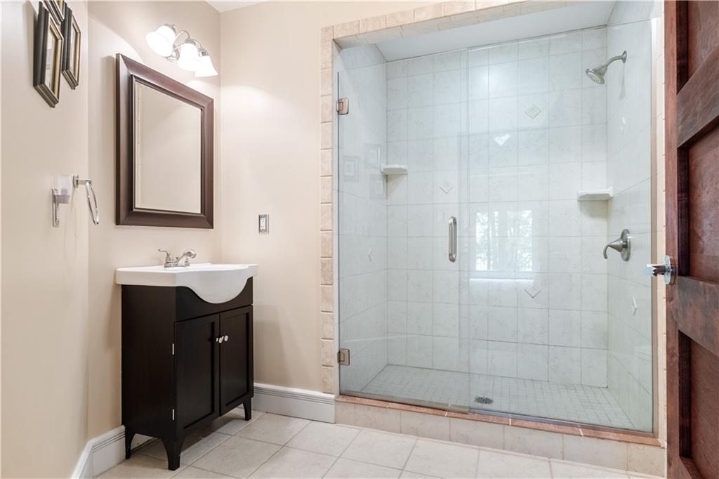 139 Witherow Road Sewickley, PA 15143 - Photo 28 of 41 a bathroom with a sink a mirror and shower