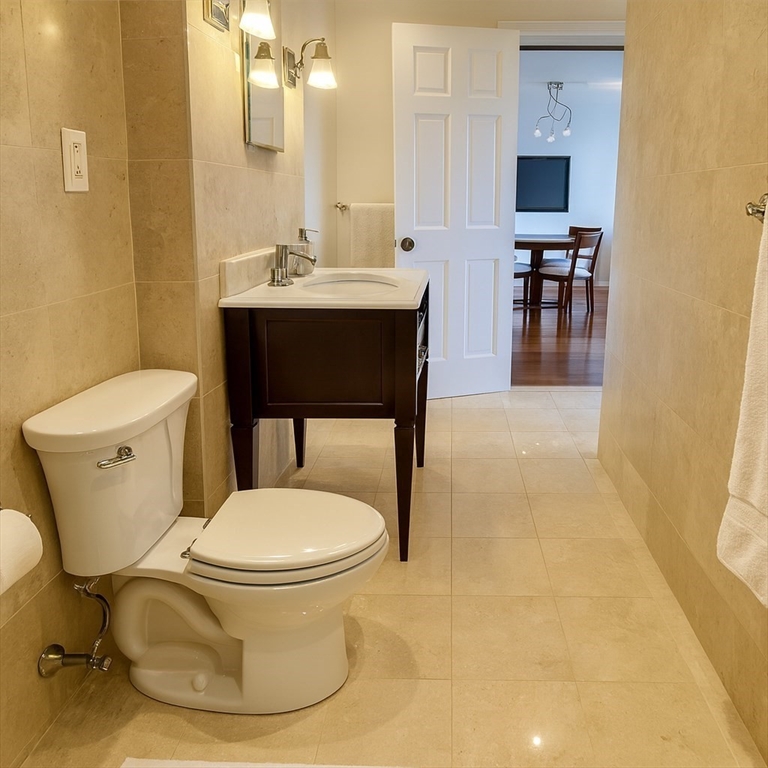 151 Tremont Street, Unit 24U Boston, MA 02111 - Photo 15 of 29 a bathroom with a sink toilet and a mirror