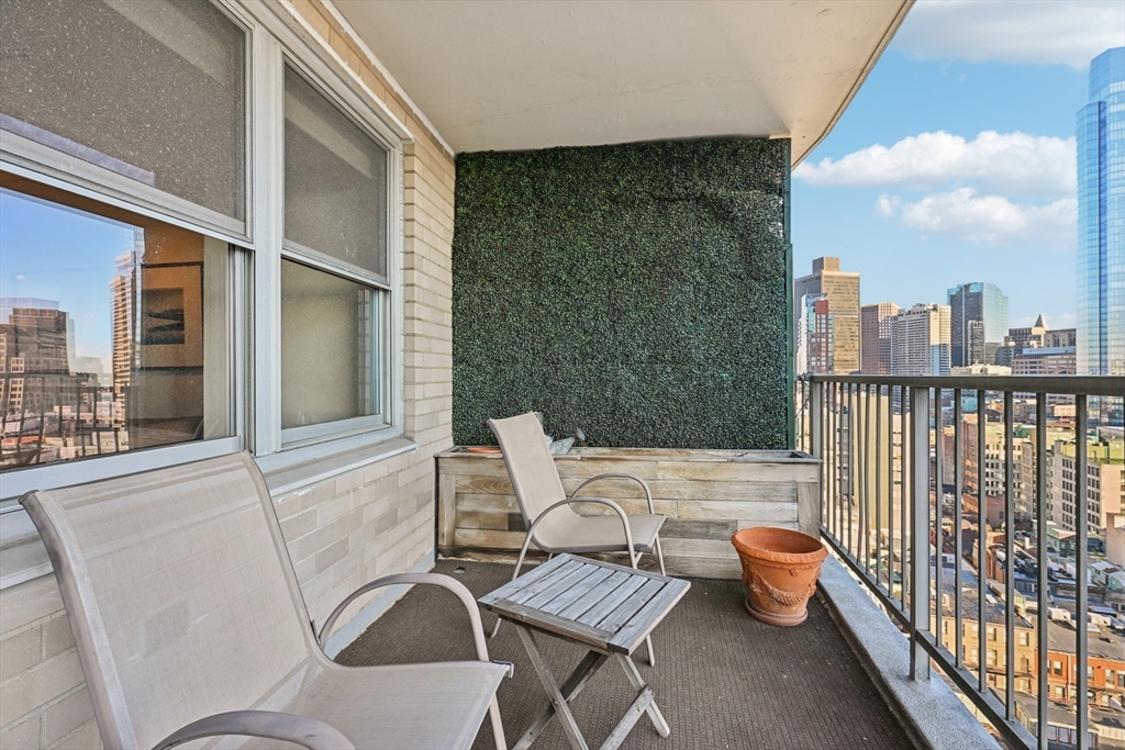 151 Tremont Street, Unit 24U Boston, MA 02111 - Photo 17 of 29 a view of a chairs and table on the balcony