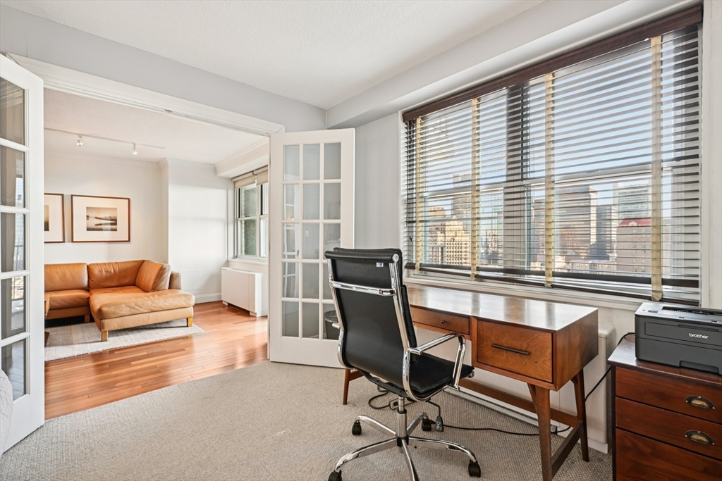 151 Tremont Street, Unit 24U Boston, MA 02111 - Photo 9 of 29 a view of a livingroom with workspace and a couch