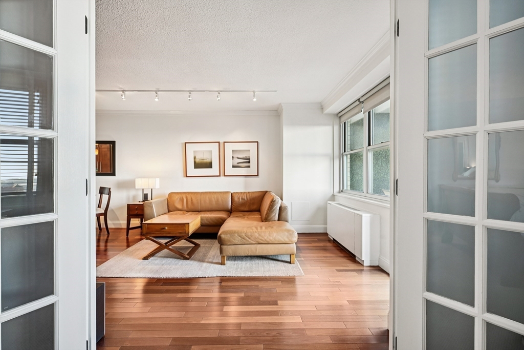151 Tremont Street, Unit 24U Boston, MA 02111 - Photo 10 of 29 a living room with furniture window and a wooden floor