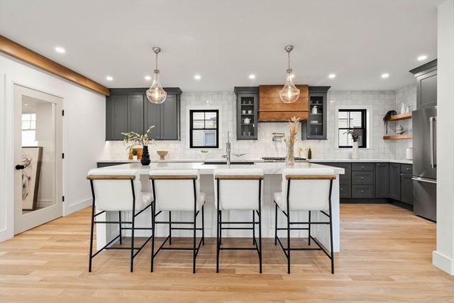 a kitchen with counter space and chairs in it
