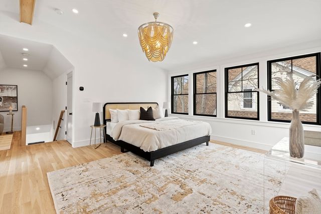 a bedroom with a large bed and a large window