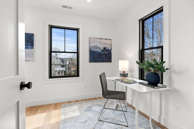 a view of a workspace with furniture and a potted plant