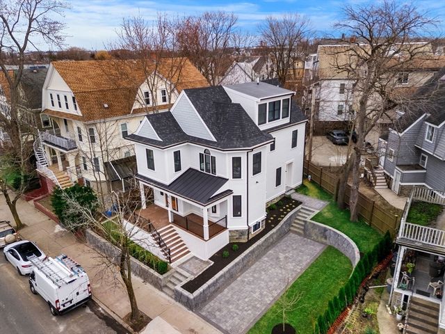 an aerial view of a house with a yard