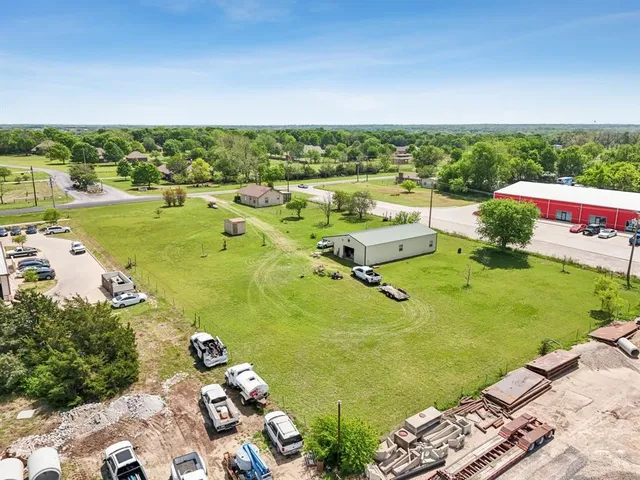 an aerial view of a residential houses with outdoor space