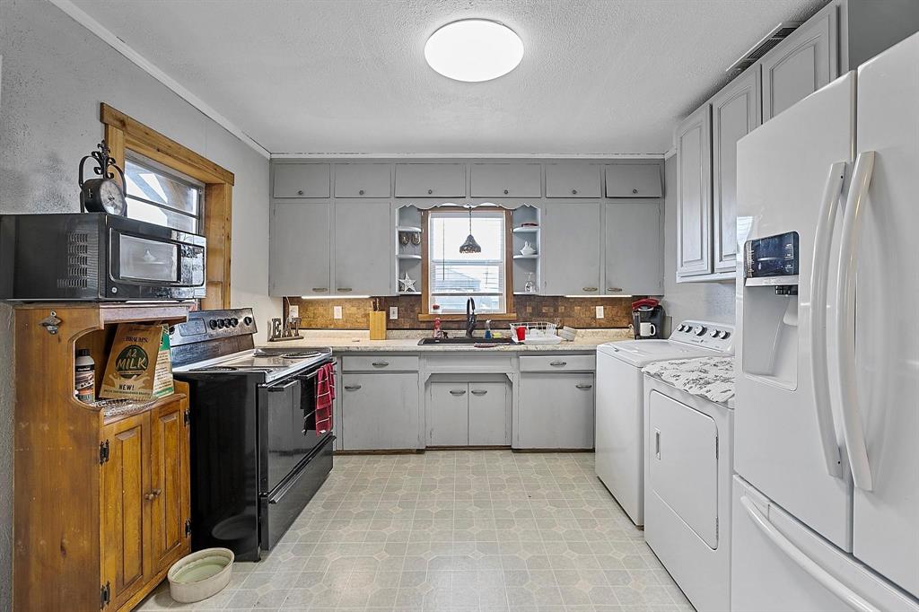 2011 Miller Road Melissa, TX 75454 - Photo 34 of 35 a kitchen with a sink stove and refrigerator