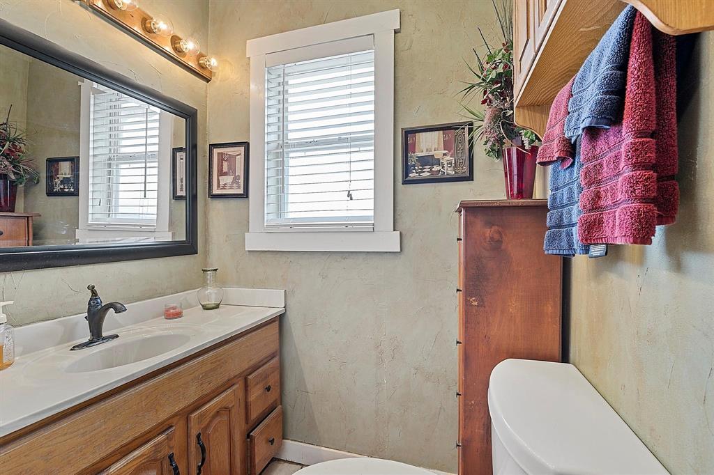 2011 Miller Road Melissa, TX 75454 - Photo 35 of 35 a bathroom with a sink a toilet and a mirror