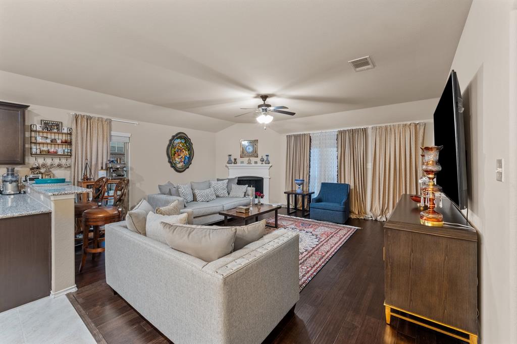 201 Whitman Drive McKinney, TX 75072 - Photo 14 of 33 a living room with furniture a fireplace and a large window