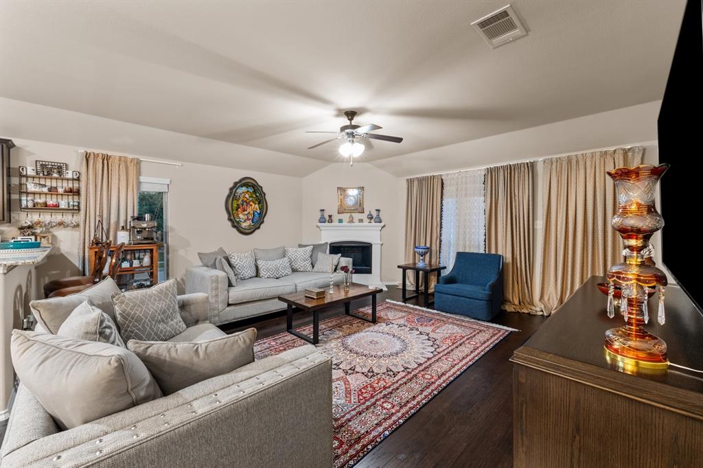 201 Whitman Drive McKinney, TX 75072 - Photo 16 of 33 a living room with furniture a fireplace and a window