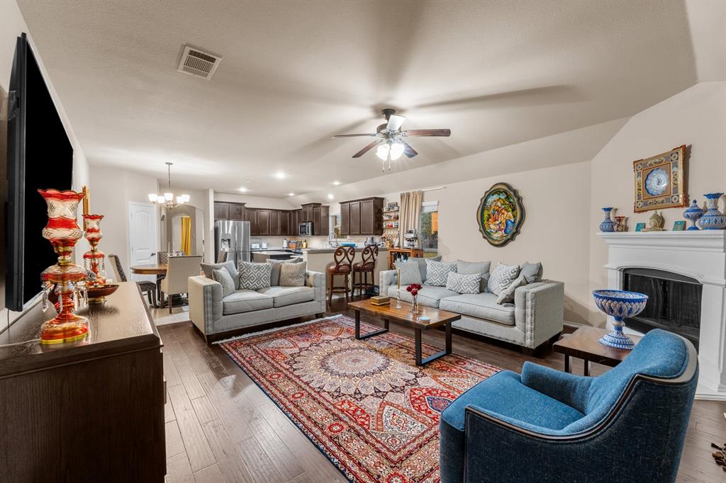 201 Whitman Drive McKinney, TX 75072 - Photo 17 of 33 a living room with furniture fireplace and a flat screen tv