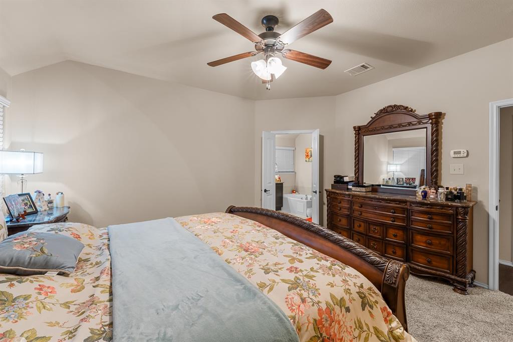 201 Whitman Drive McKinney, TX 75072 - Photo 23 of 33 a bedroom with a bed and a flat screen tv