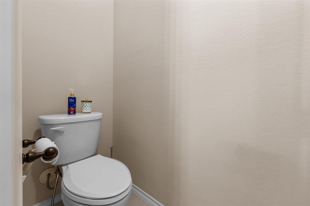 201 Whitman Drive McKinney, TX 75072 - Photo 26 of 33 a white toilet sitting next to a white wall