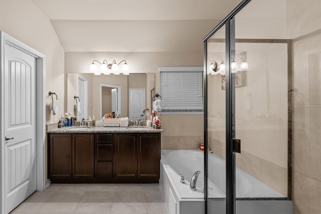 201 Whitman Drive McKinney, TX 75072 - Photo 27 of 33 a bathroom with a double vanity sink mirror and shower