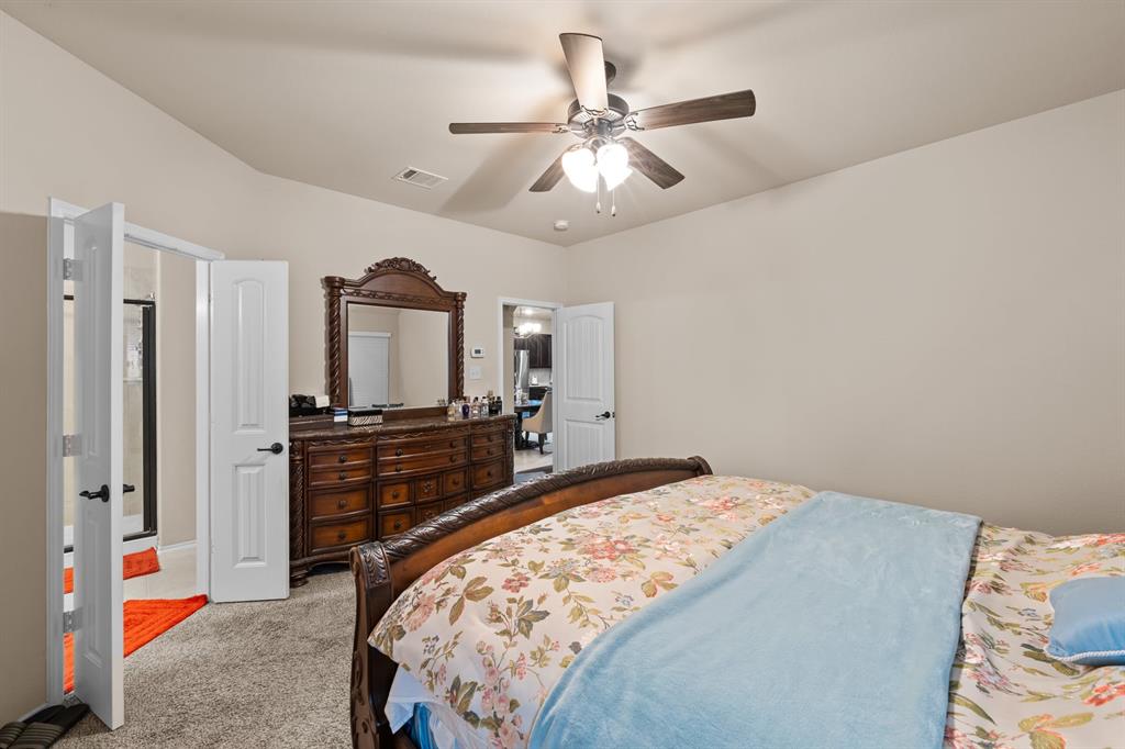 201 Whitman Drive McKinney, TX 75072 - Photo 28 of 33 a bedroom with a bed and a chandelier