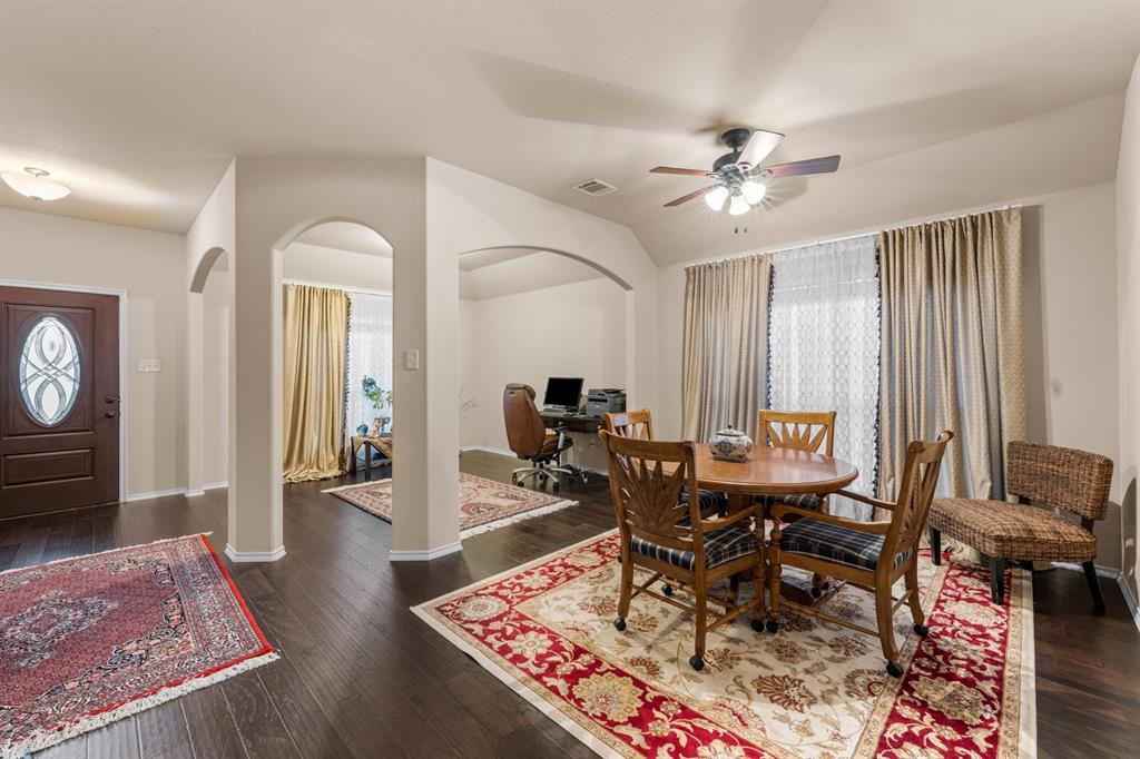 201 Whitman Drive McKinney, TX 75072 - Photo 5 of 33 a living room with furniture a rug and a chandelier