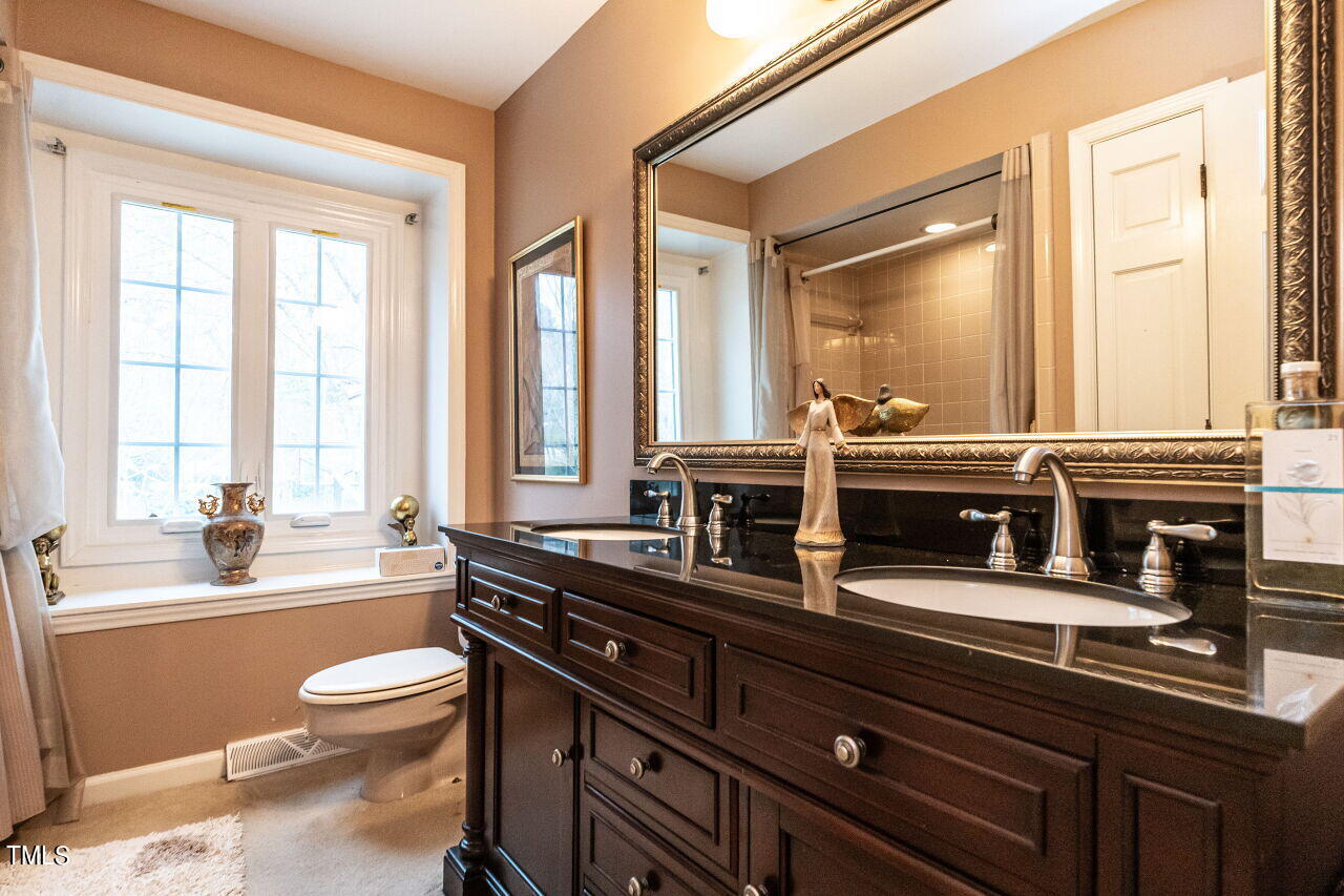 609 Queensferry Road Cary, NC 27511 - Photo 11 of 12 a view of bathroom with a large tub and sink