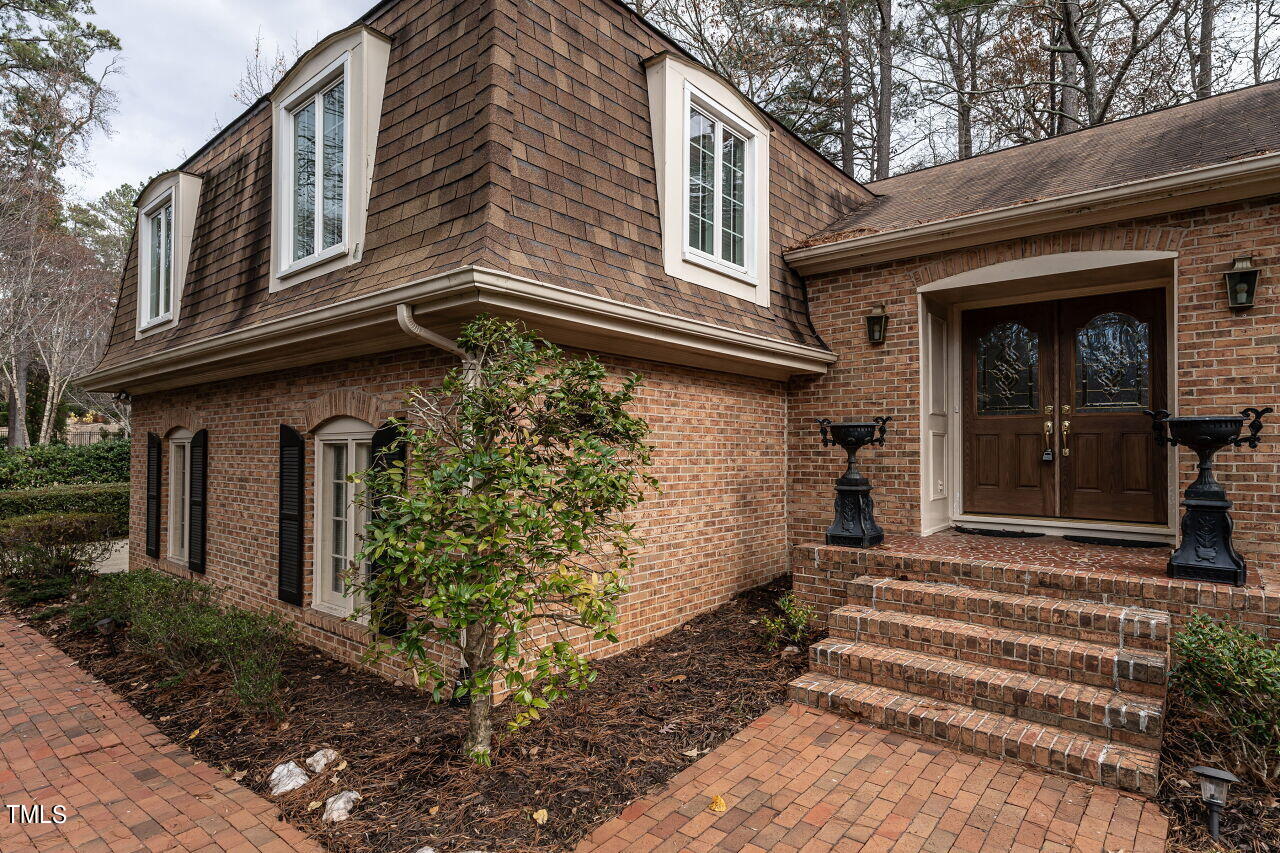 609 Queensferry Road Cary, NC 27511 - Photo 2 of 12 a front view of a house with a garden
