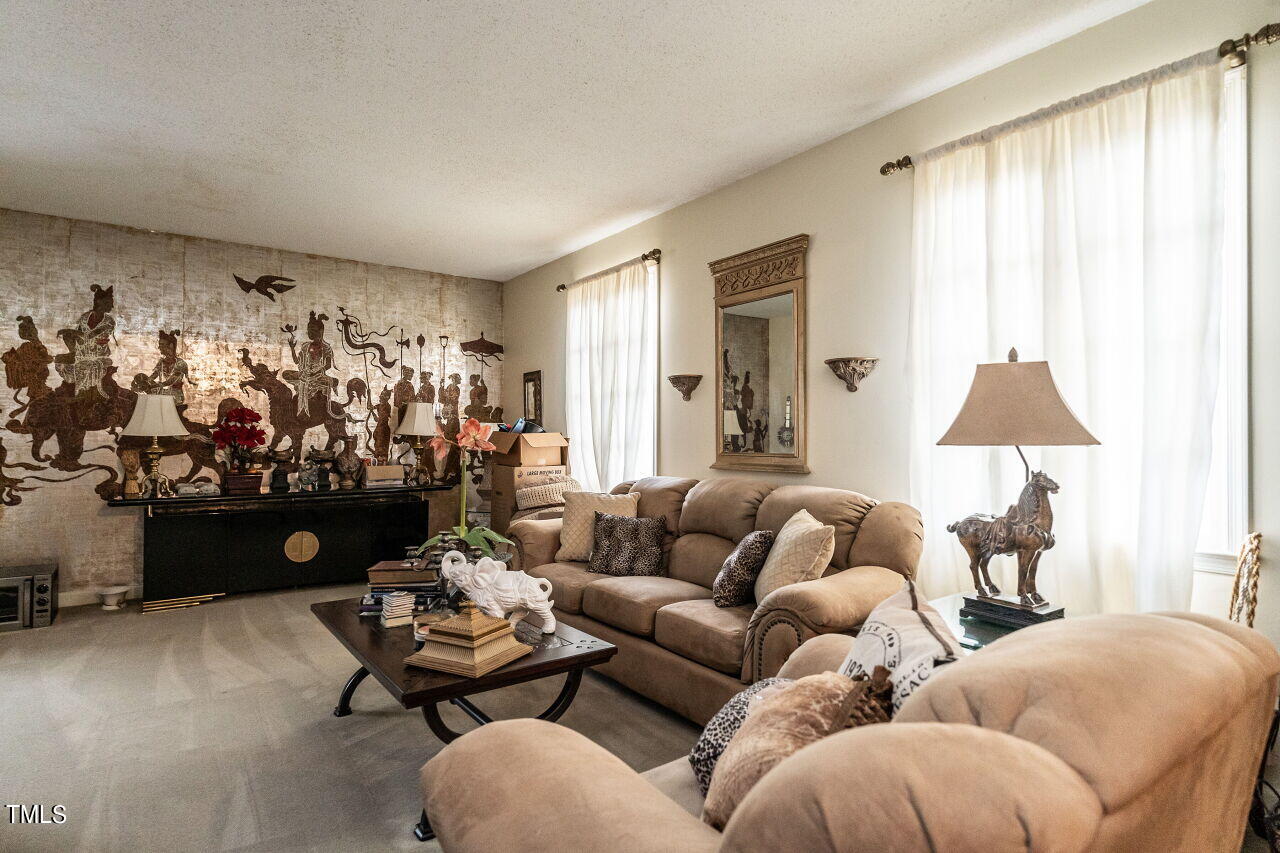 609 Queensferry Road Cary, NC 27511 - Photo 4 of 12 a living room with furniture a rug and a window