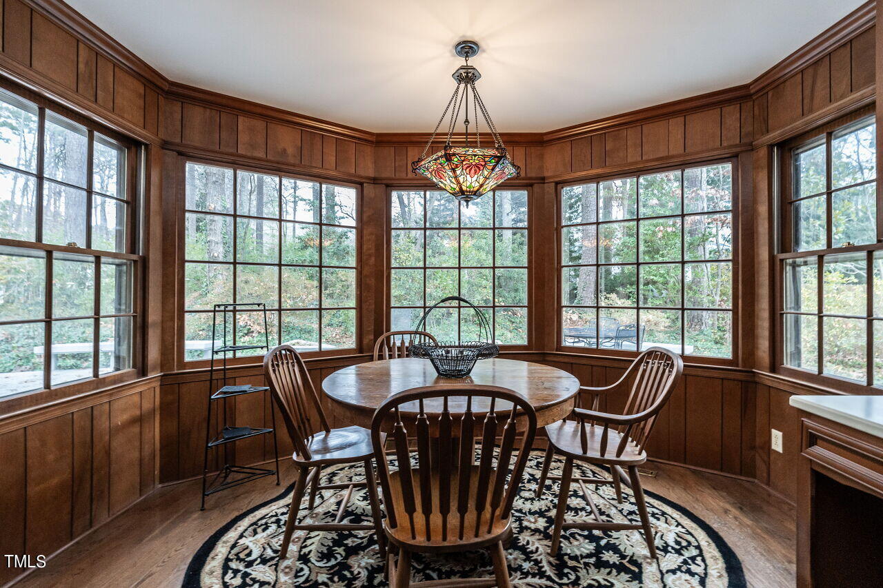 609 Queensferry Road Cary, NC 27511 - Photo 8 of 12 a dining room with furniture a chandelier and wooden floor