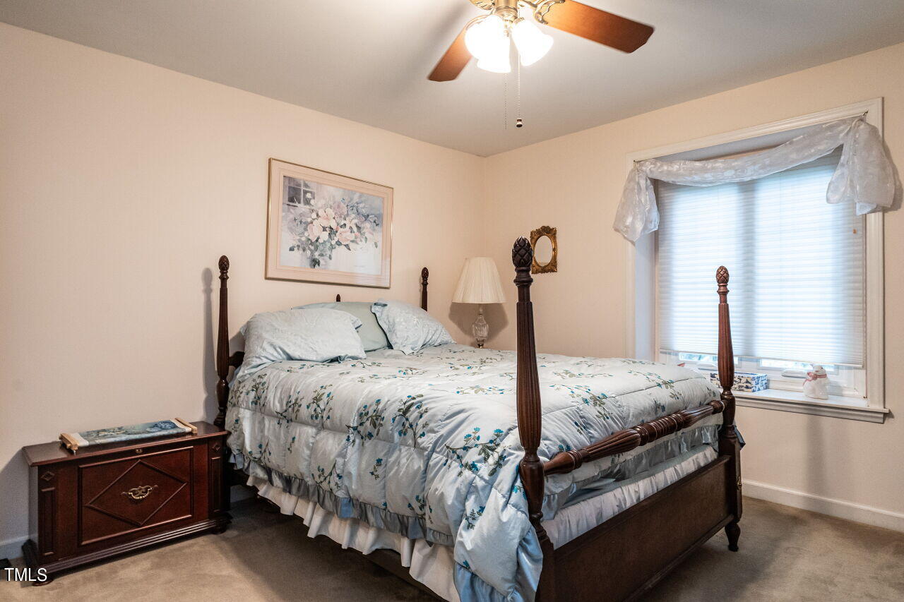 609 Queensferry Road Cary, NC 27511 - Photo 10 of 12 a bed room with a bed and a chandelier